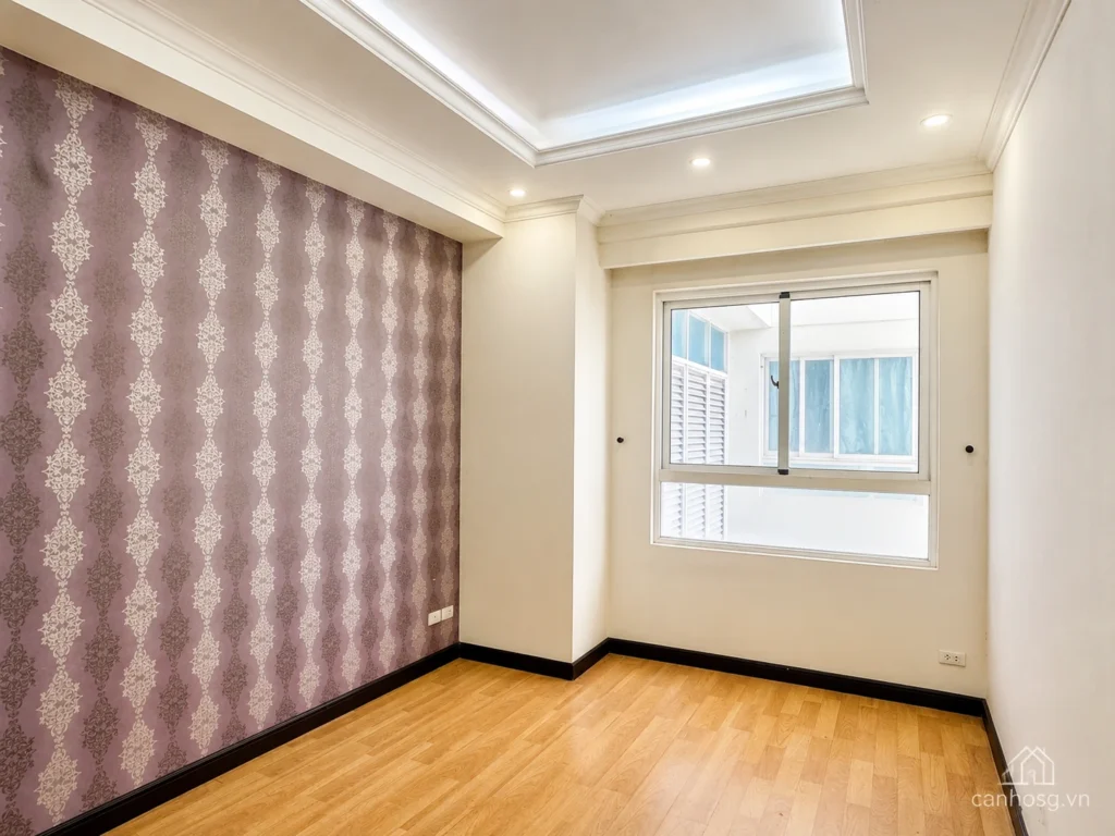 Phòng ngủ căn hộ The Flemington 96m² với sàn gỗ, tường nhấn hoa văn màu tím và cửa sổ lấy sáng.